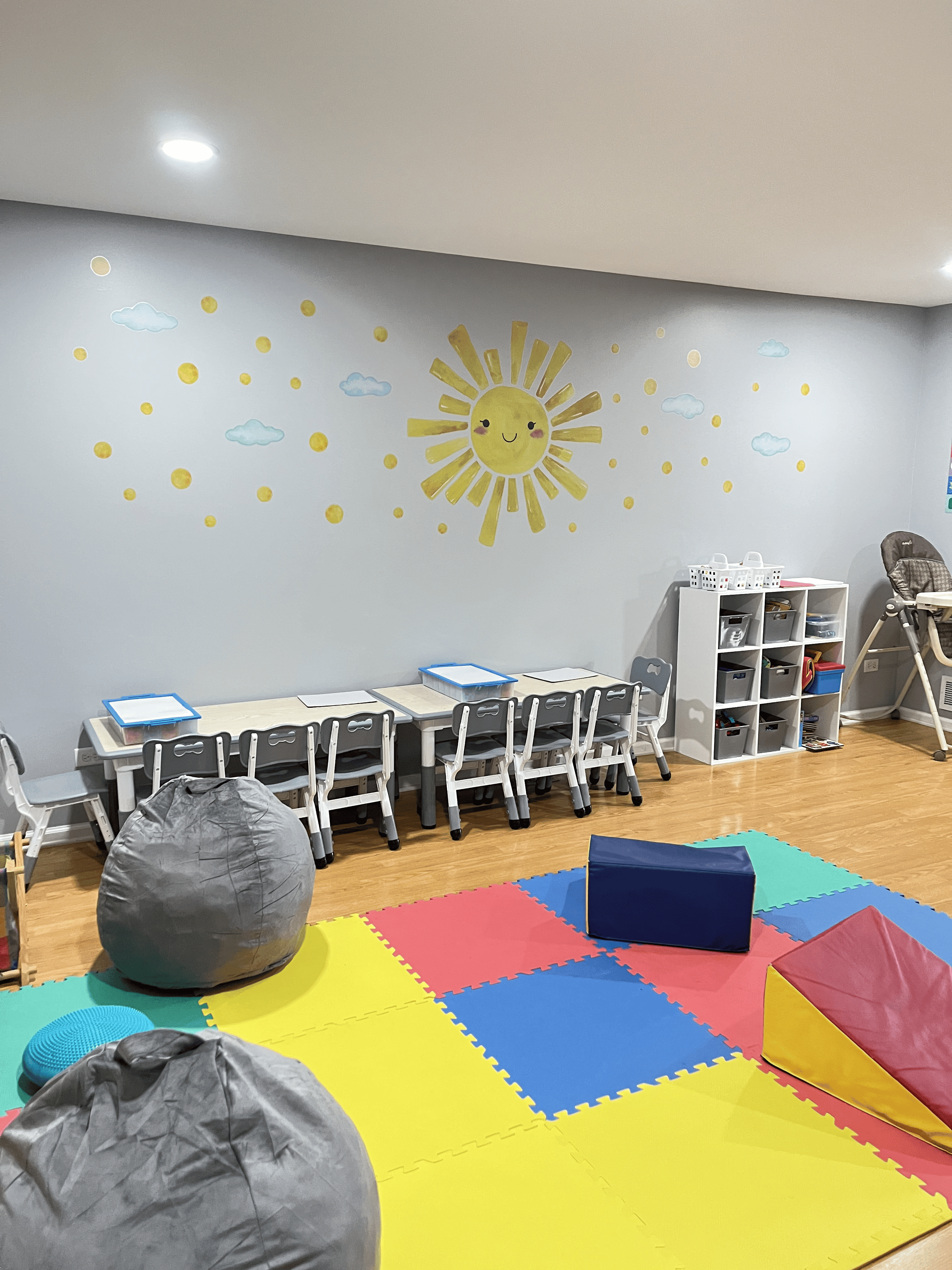 Reading and activity area with sun mural and kids' seating